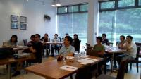 Participants attentively listen to colleagues' sharing.